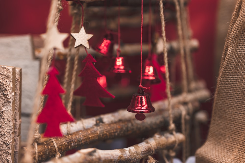 red and silver bell hanging on brown tree branch