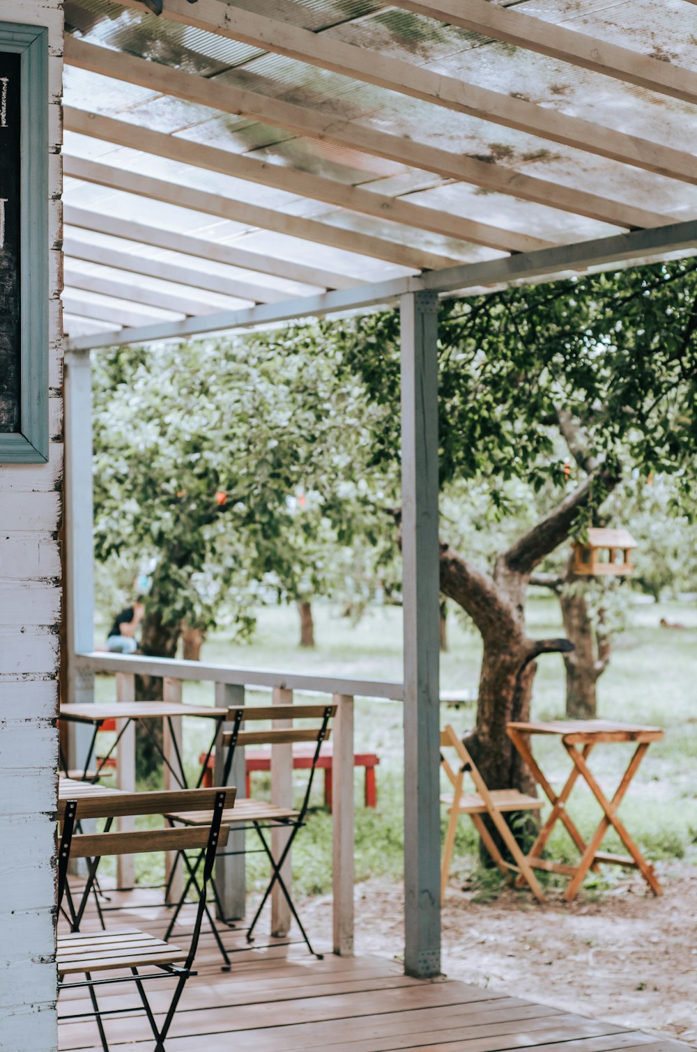 brown wooden chair near green tree during daytime