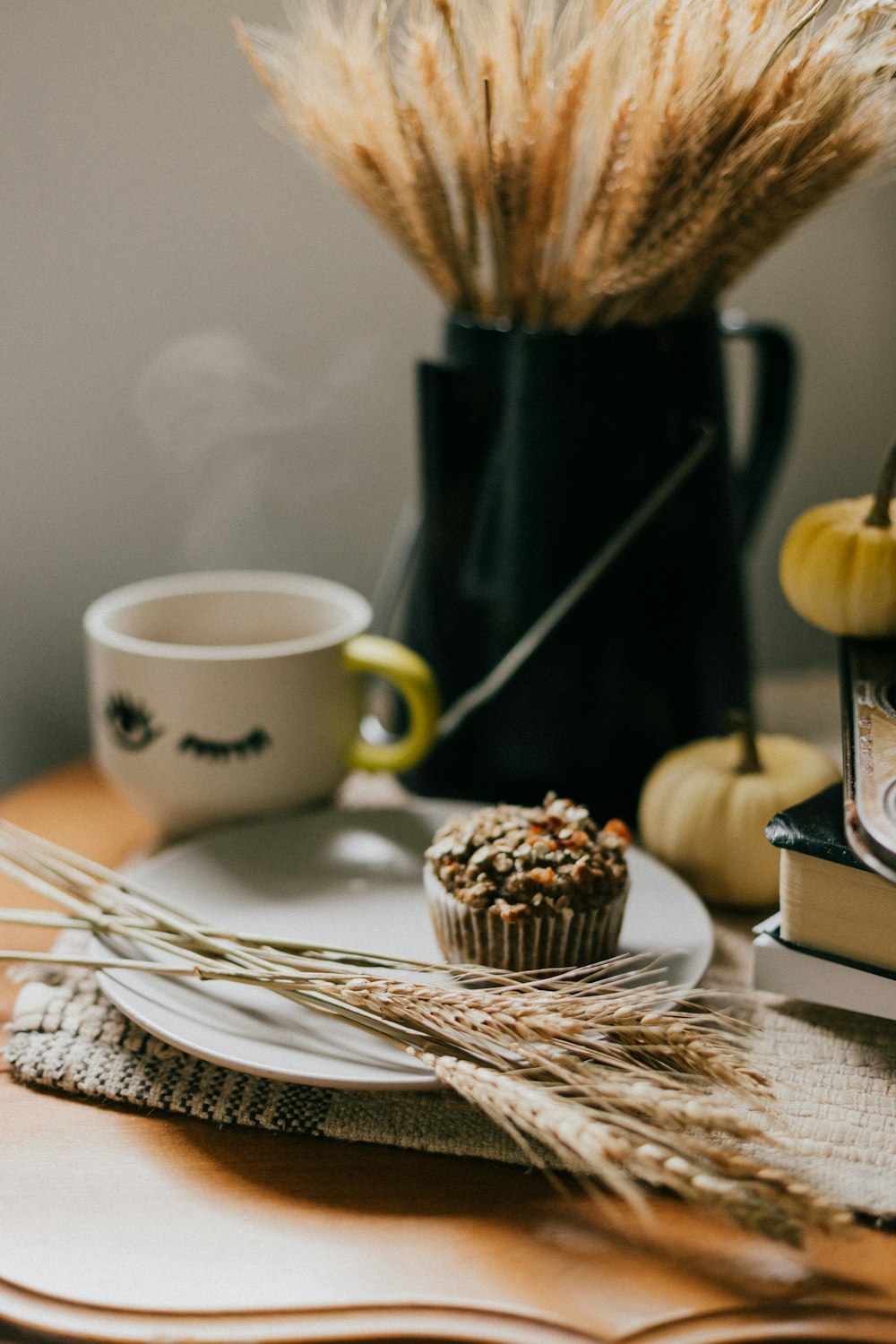 white ceramic mug on white and brown wooden table