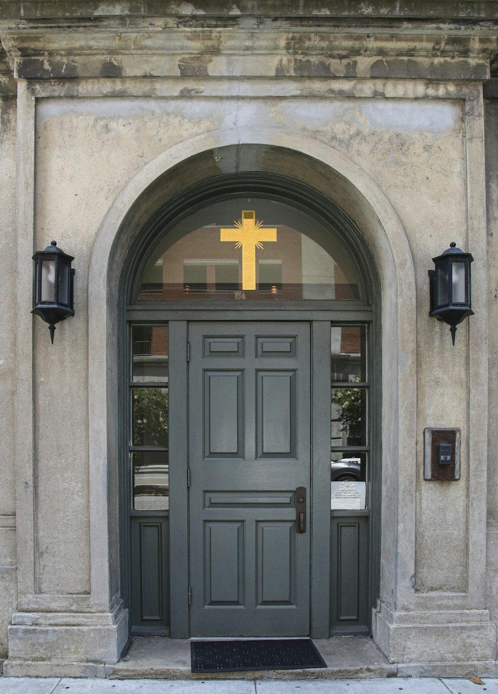 black wooden door with cross