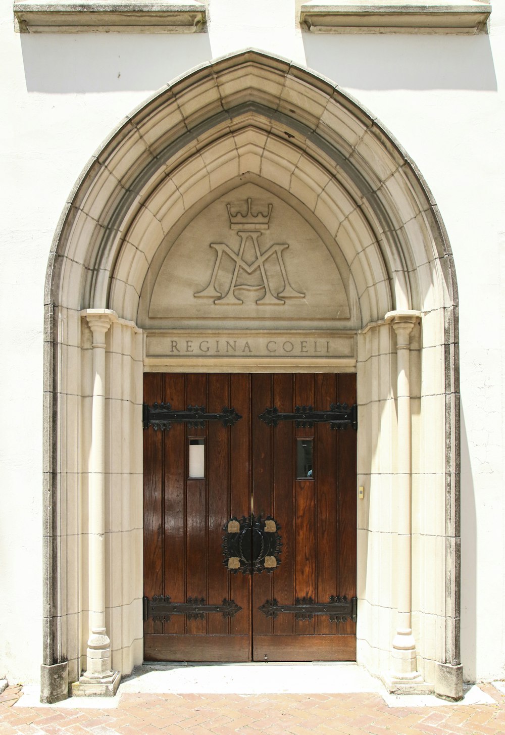 brown wooden door on white concrete building