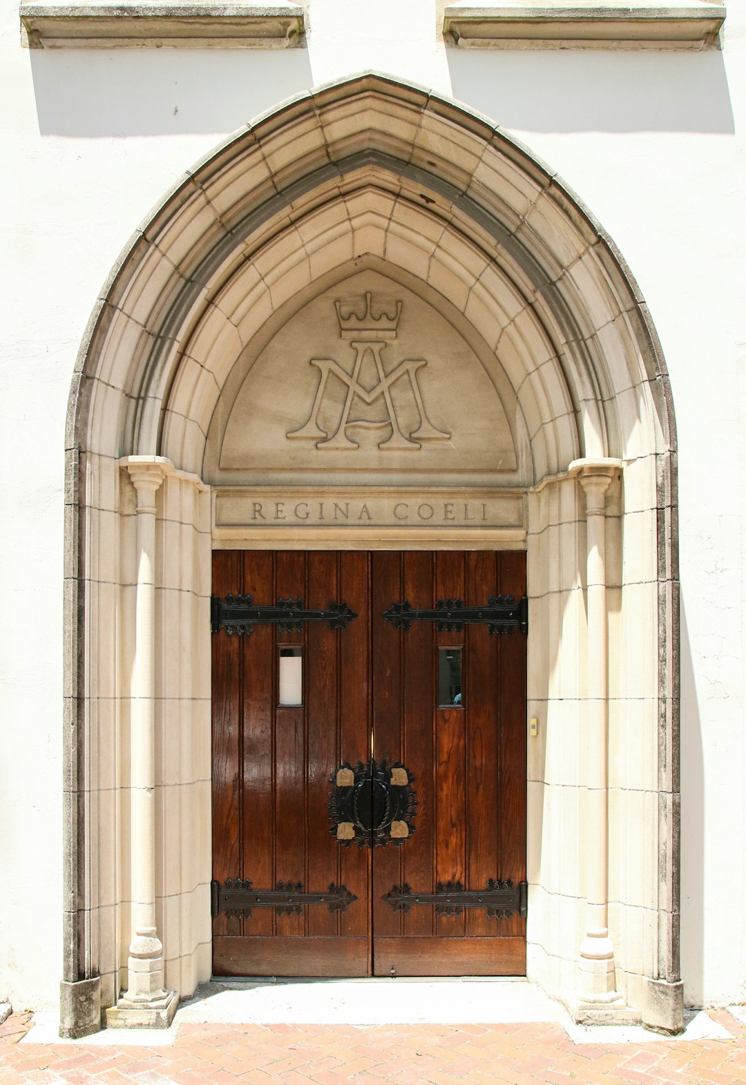 brown wooden door on white concrete building