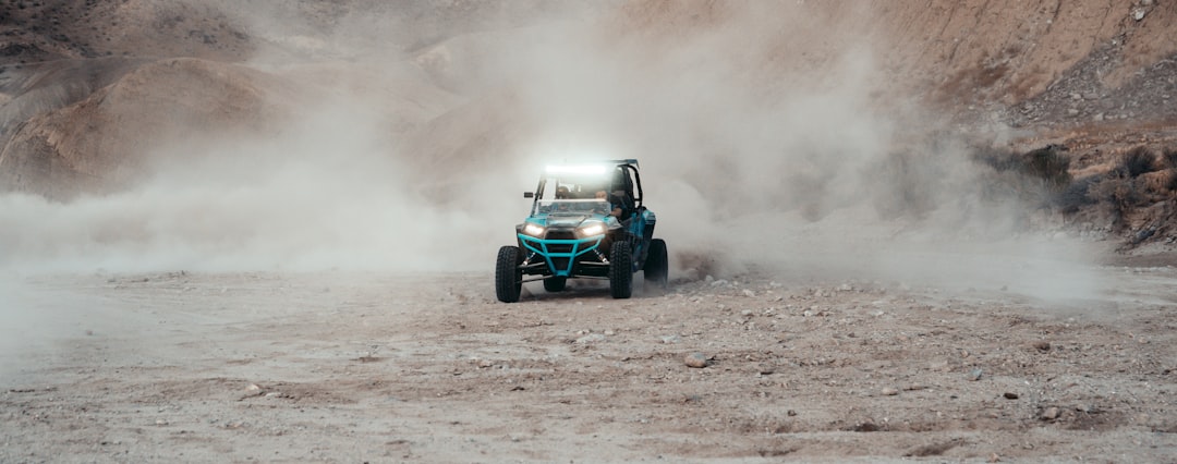 black and blue f 1 car on brown soil,
