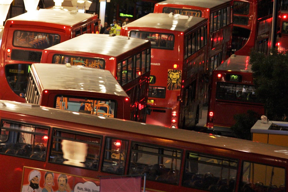 red double decker bus on road during nighttime