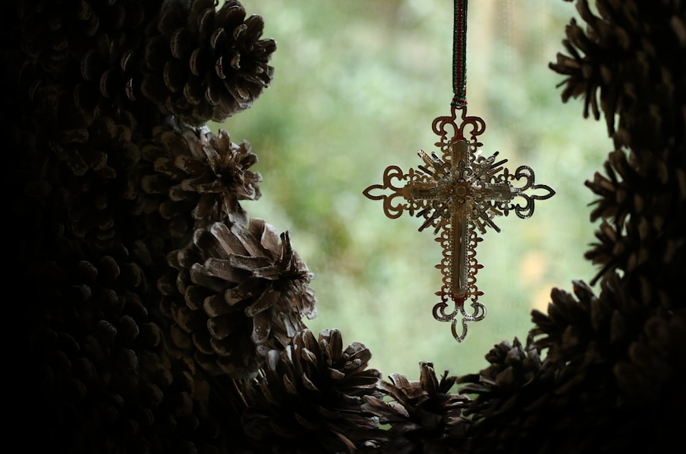 gold star ornament on brown pine cone