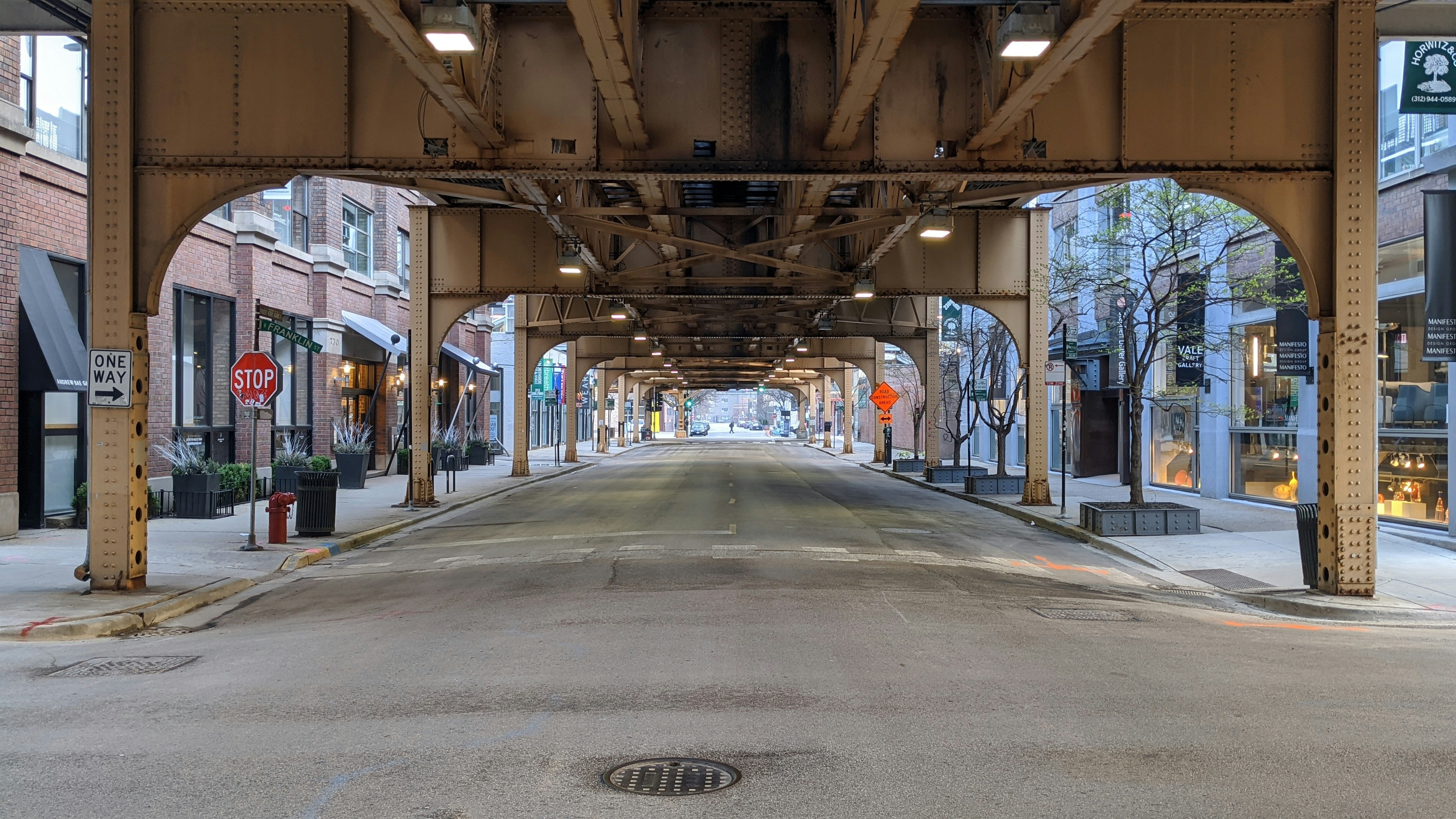 empty road in between buildings during daytime elevated teams background