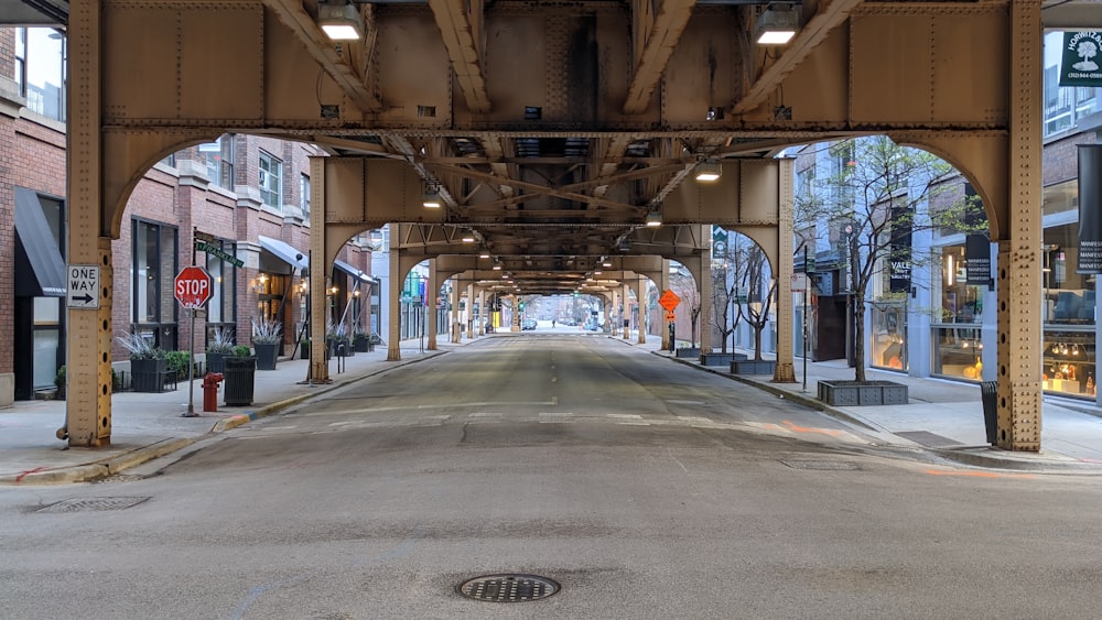 empty road in between buildings during daytime