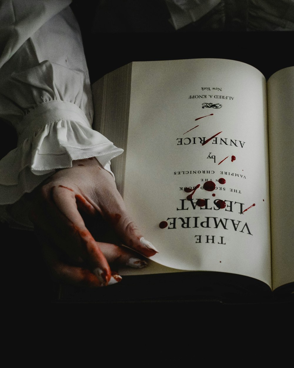 a person holding an open book in their hands