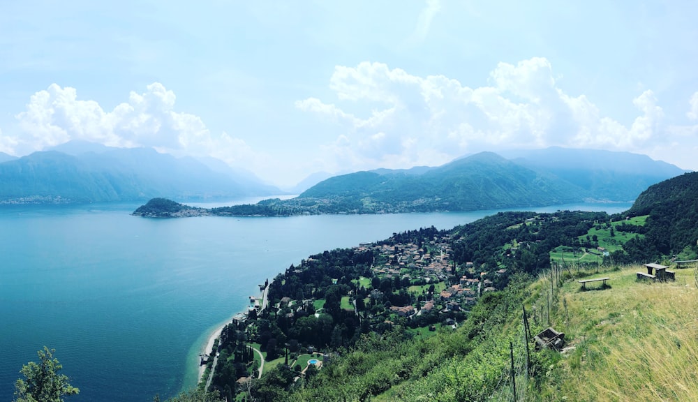 green mountains near body of water during daytime