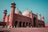 The Badshahi Mosque with red sandstone walls and white domes in Lahore, Pakistan
