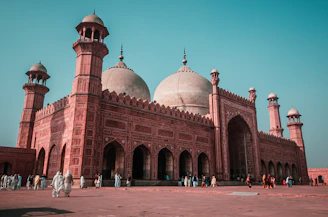 The Badshahi Mosque with red sandstone walls and white domes in Lahore, Pakistan