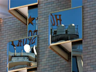 Sparkling clean storefront windows reflecting a bright blue sky.