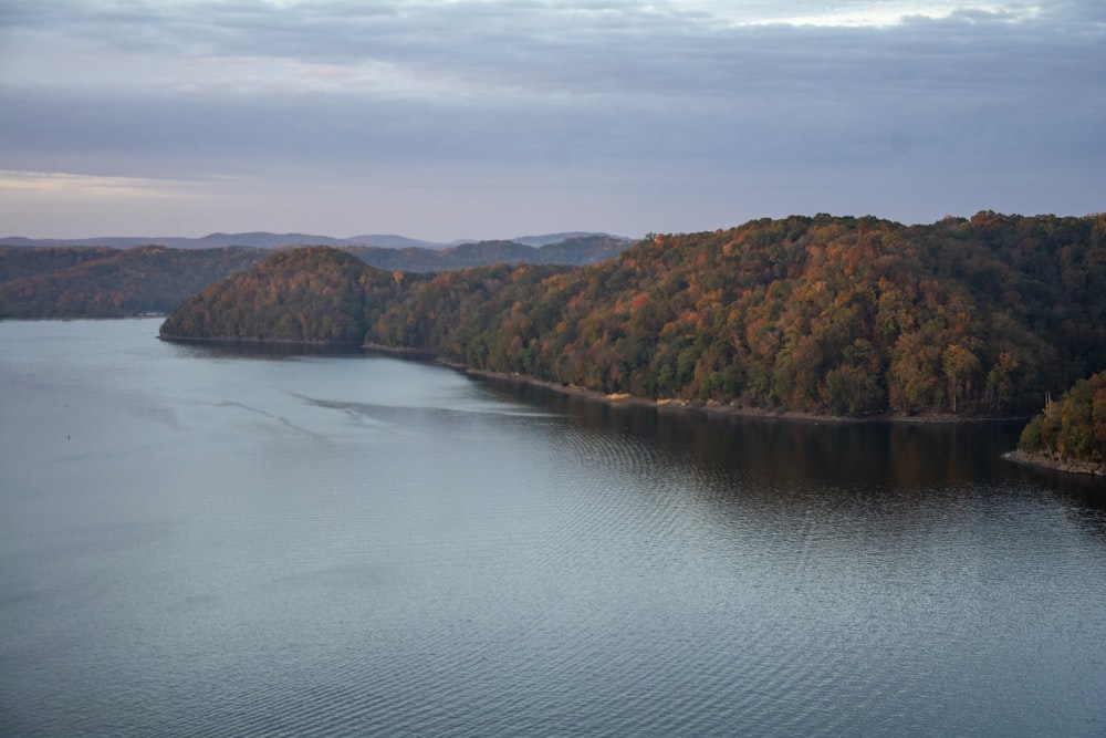 brown and green mountains beside body of water during daytime