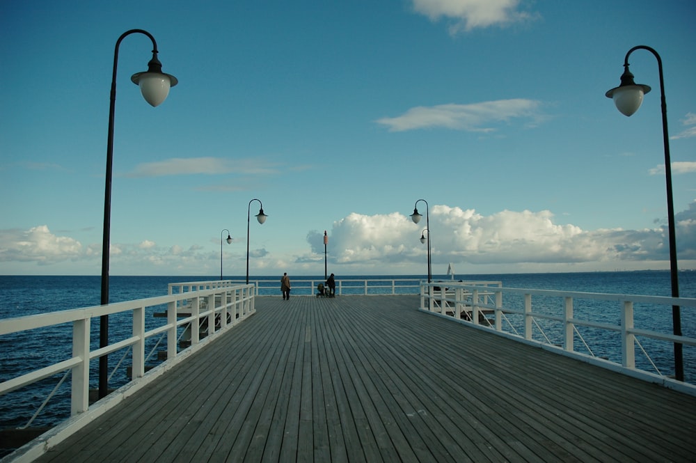 people walking on wooden dock during daytime