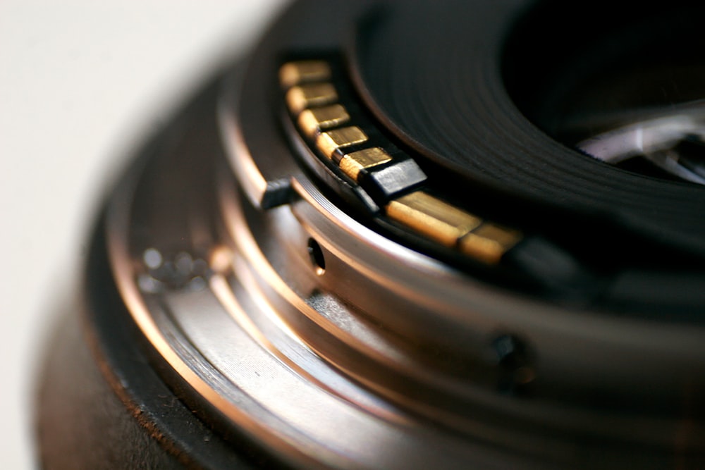 black camera lens on brown wooden table