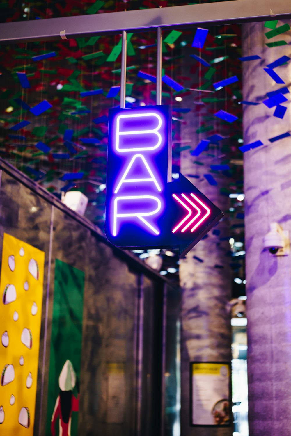 a neon sign hanging from the ceiling of a building