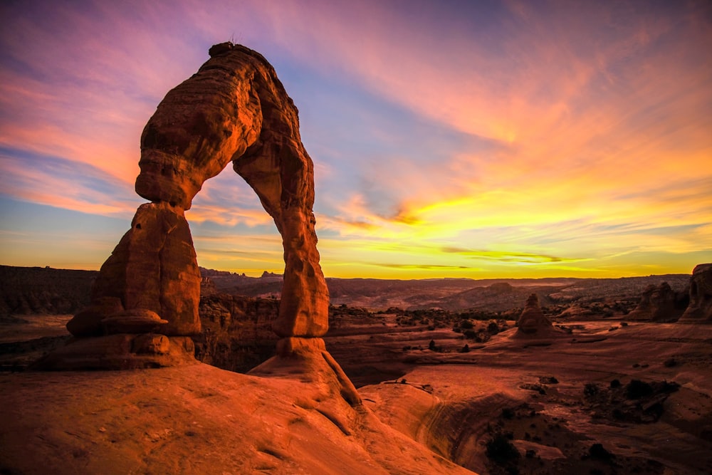 brown rock formation under white clouds during daytime