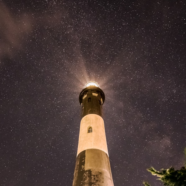 white and black lighthouse under starry nightby Samantha Kennedy