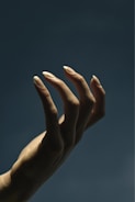 persons left hand doing peace sign