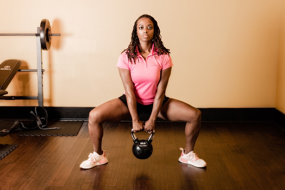 a woman holding a kettle in a gym