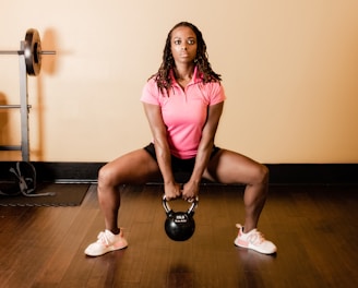 a woman holding a kettle in a gym