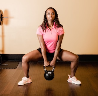 a woman holding a kettle in a gym