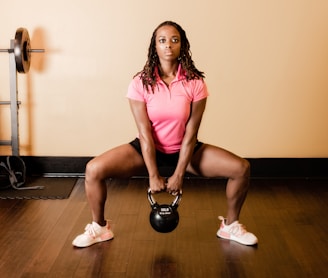 a woman holding a kettle in a gym