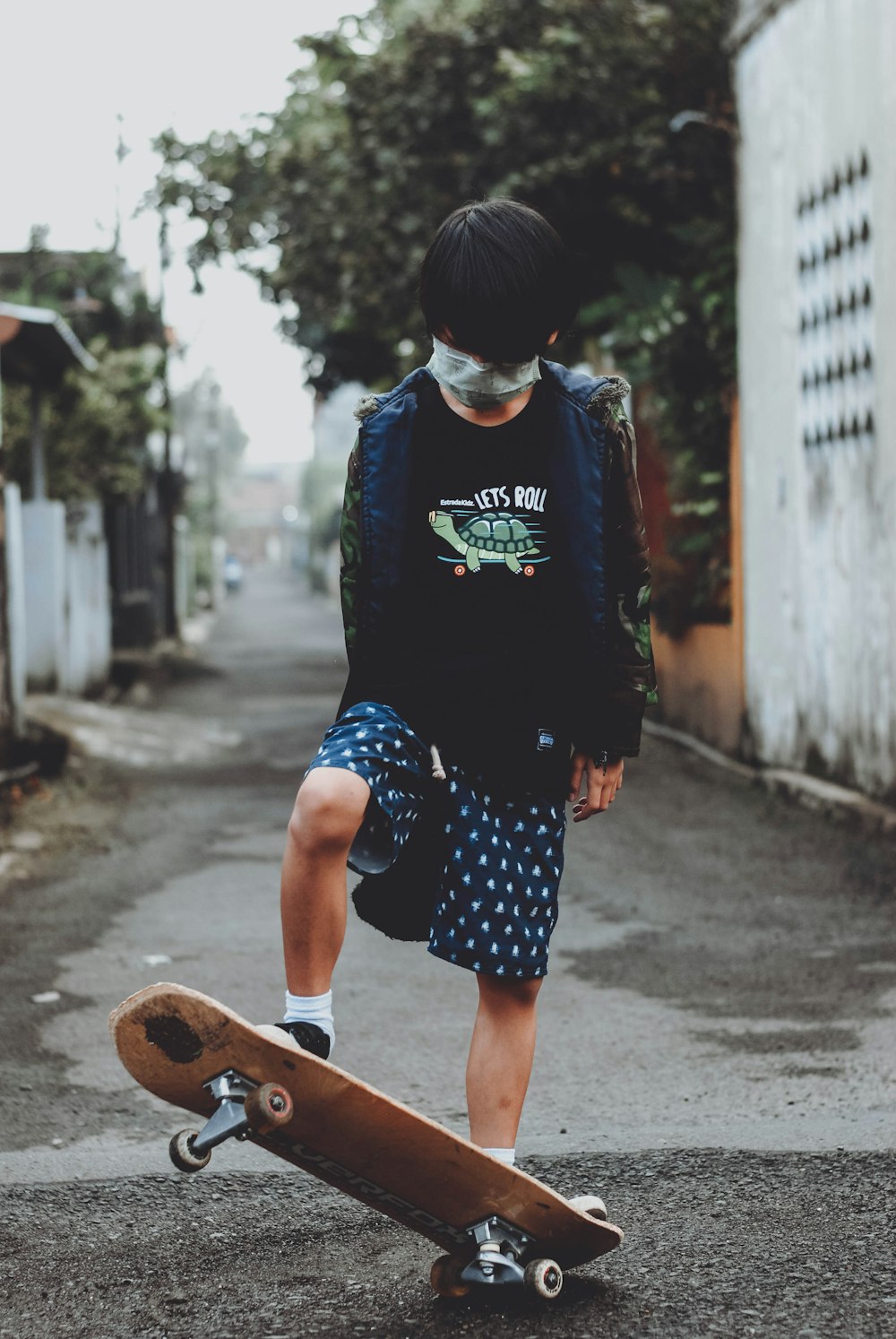 woman in blue and white crew neck t-shirt and blue denim shorts walking on street