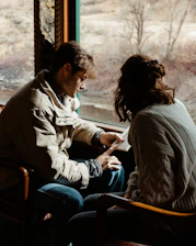 man and woman sitting on bench