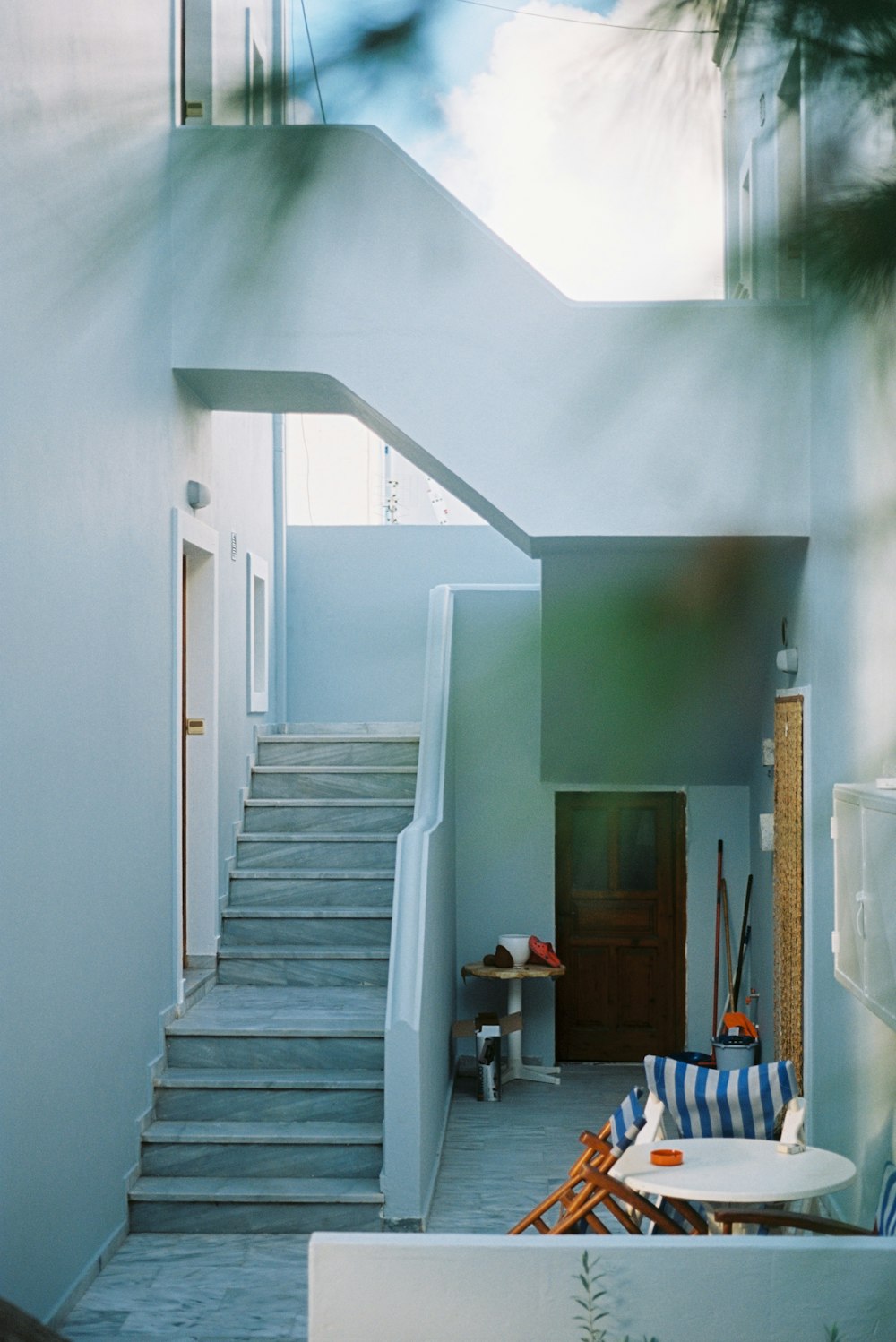 white wooden staircase near white wall