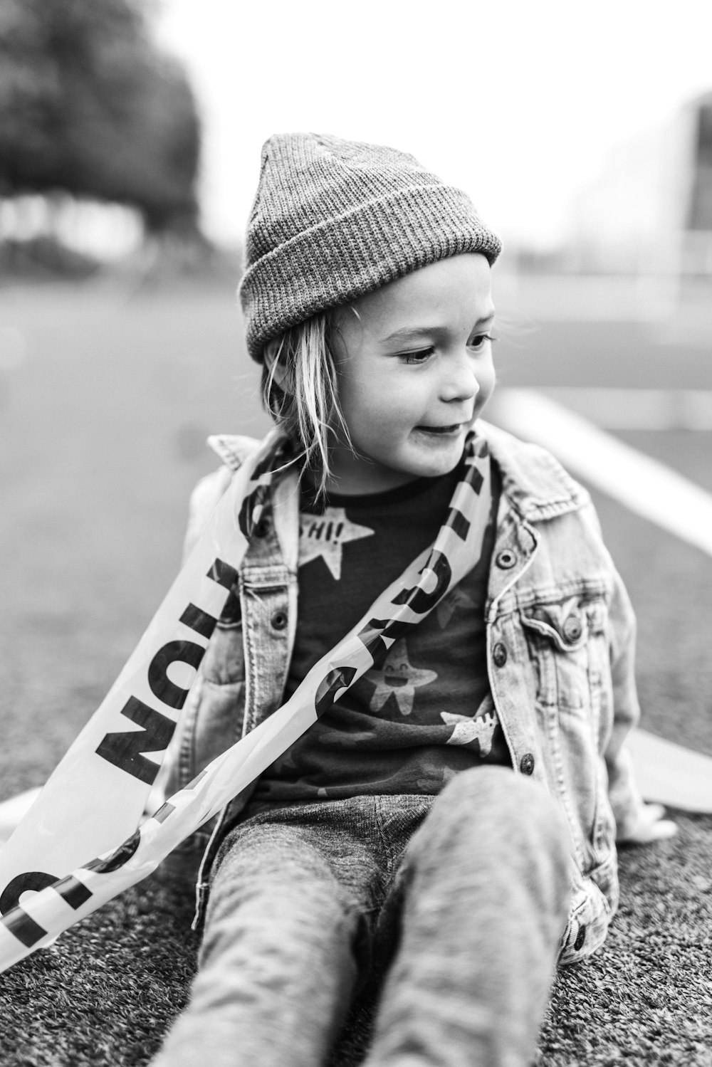 grayscale photo of child wearing knit cap and jacket