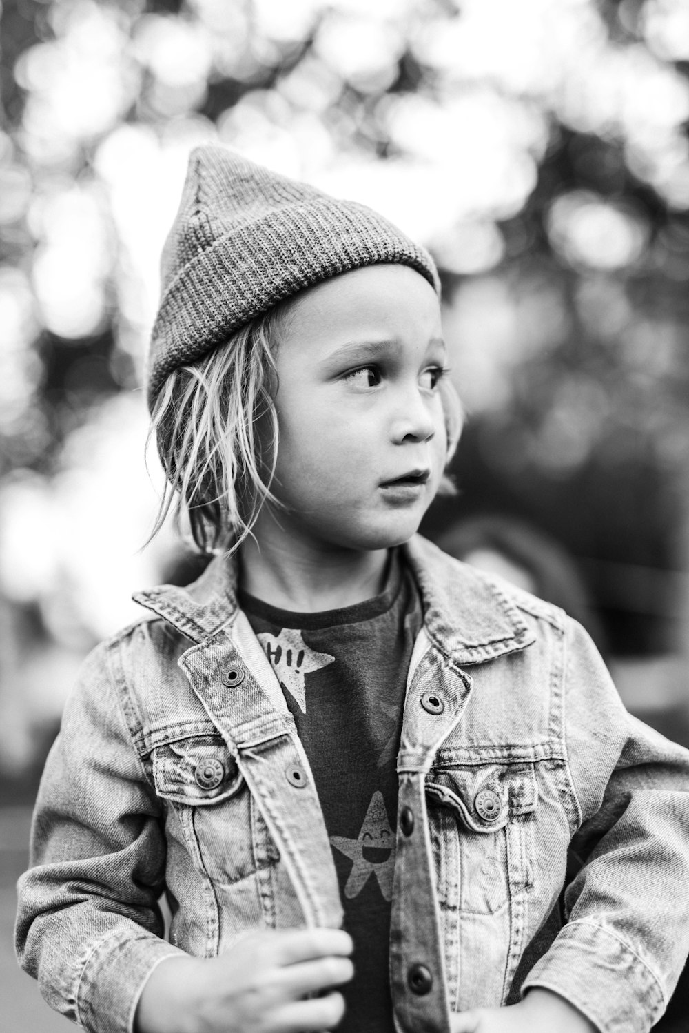 grayscale photo of girl in knit cap and jacket