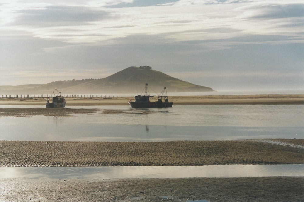 black ship on body of water during daytime