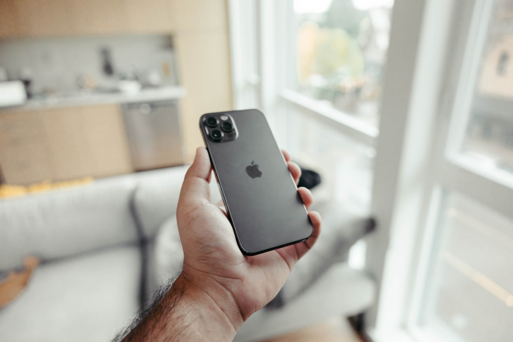 person holding black iphone 7 plus