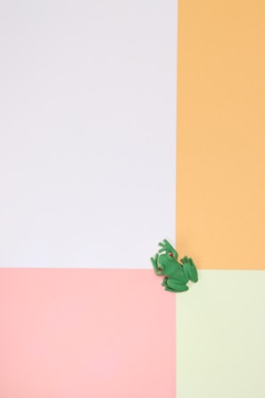 A fresh mint green puzzle piece card displaying Pip the frog sitting happily with bright eyes.