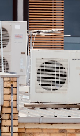 white and gray box fan on brown wooden table