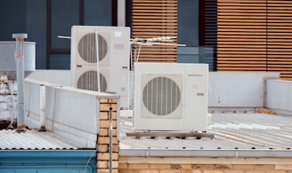 white and gray box fan on brown wooden table