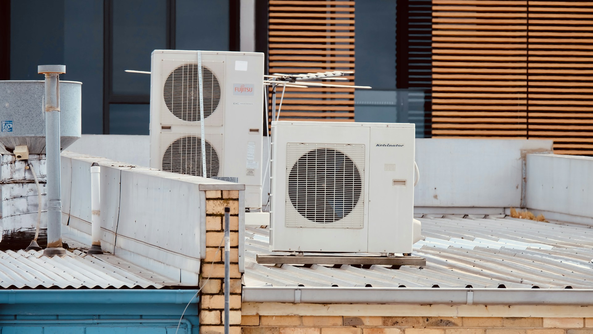 white and gray box fan on brown wooden table