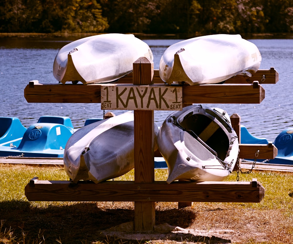 white and blue boat on brown wooden dock during daytime