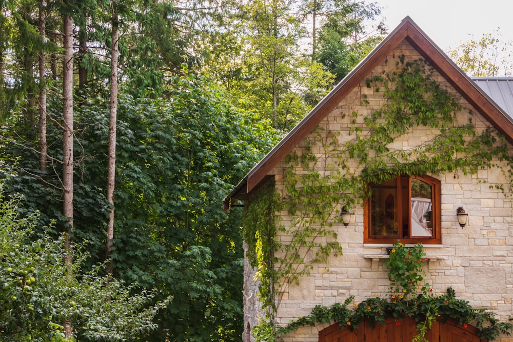 brown and white wooden house near green trees during daytime