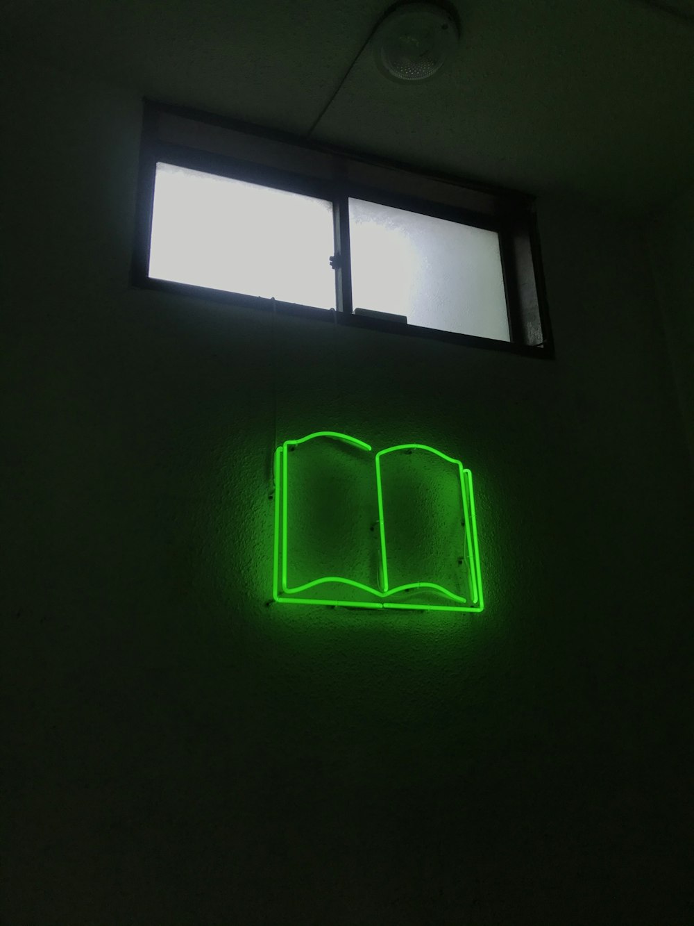 green light on black wall