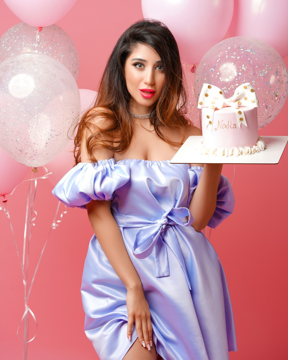 woman in blue dress holding happy birthday cake