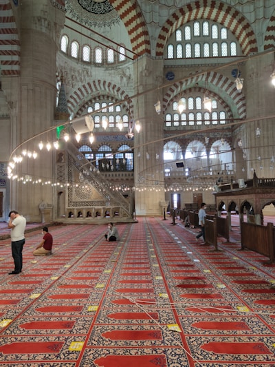 A bright, welcoming view of the mosque's main prayer hall filled with worshippers during Jumu'ah.