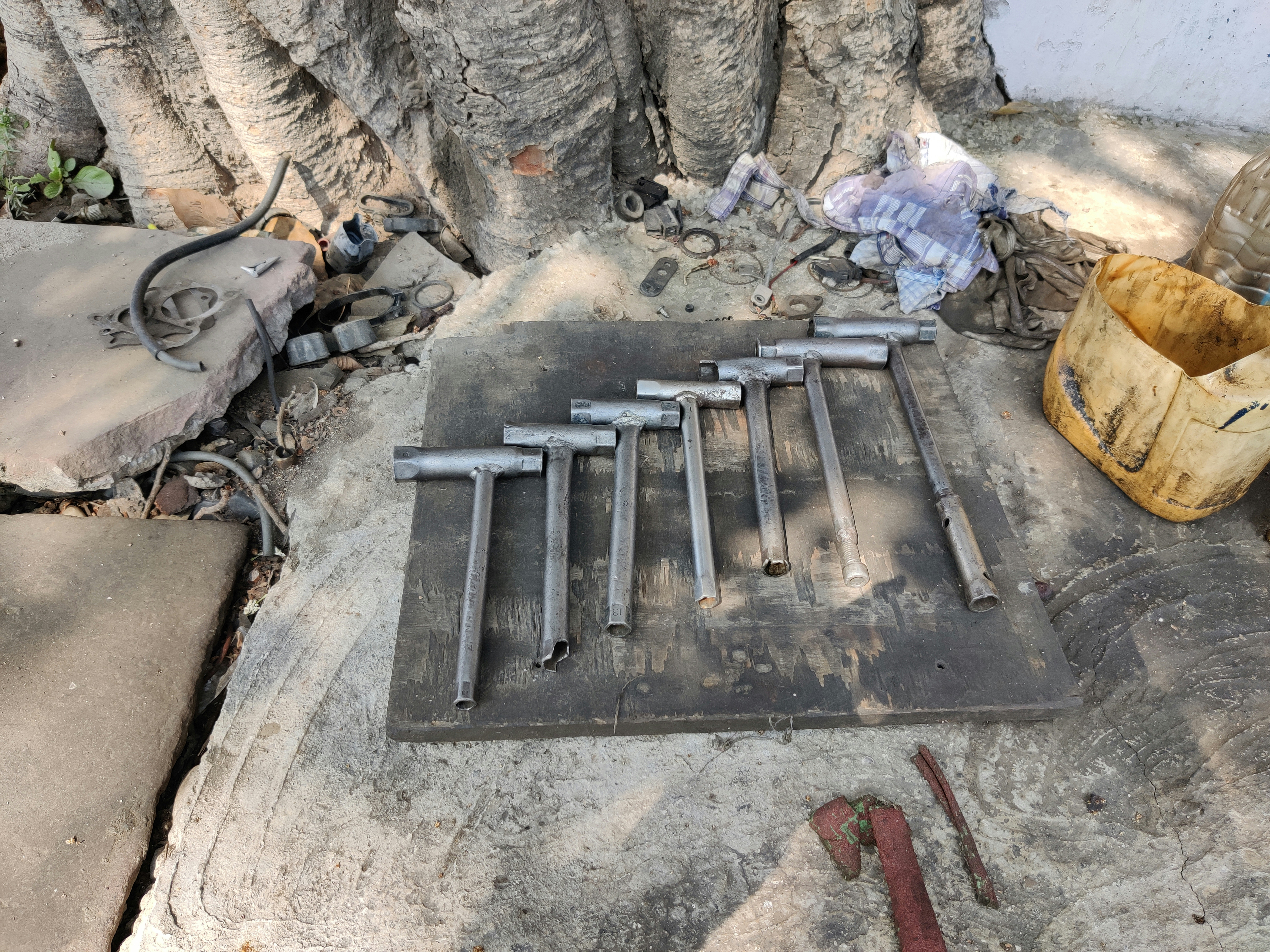 Set of transmission gears laid out on a workbench with tools.