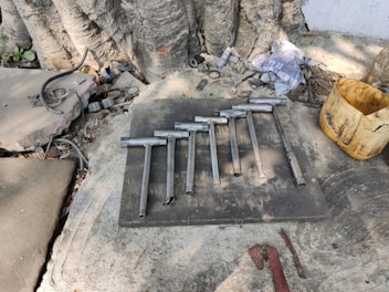 Set of durable undercarriage parts laid out on a rugged surface