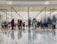 A diverse group of people enjoying shopping together in a bright, modern retail environment.