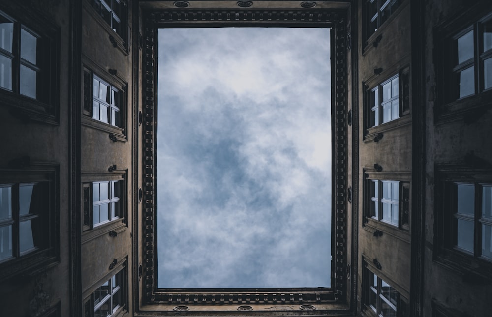 brown concrete building under white clouds during daytime