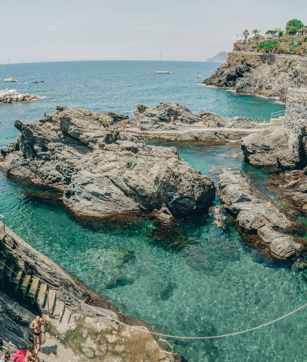 brown rock formation on body of water during daytime