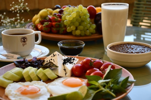 sliced fruits on white ceramic plate beside white ceramic mug with coffee