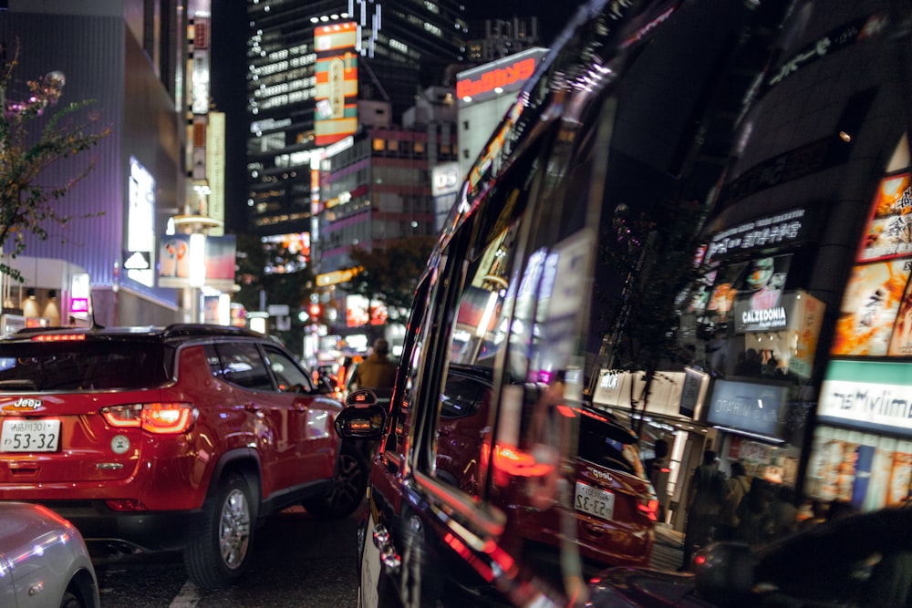 red car on the street during night time